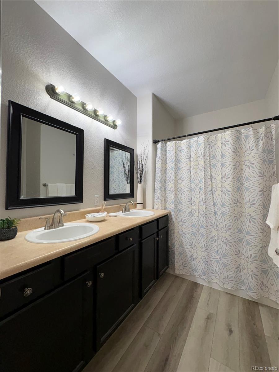 4608 Copeland Lane, Unit 101 Highlands Ranch, CO 80126 - Photo 11 of 16 a bathroom with double vanity and a mirror