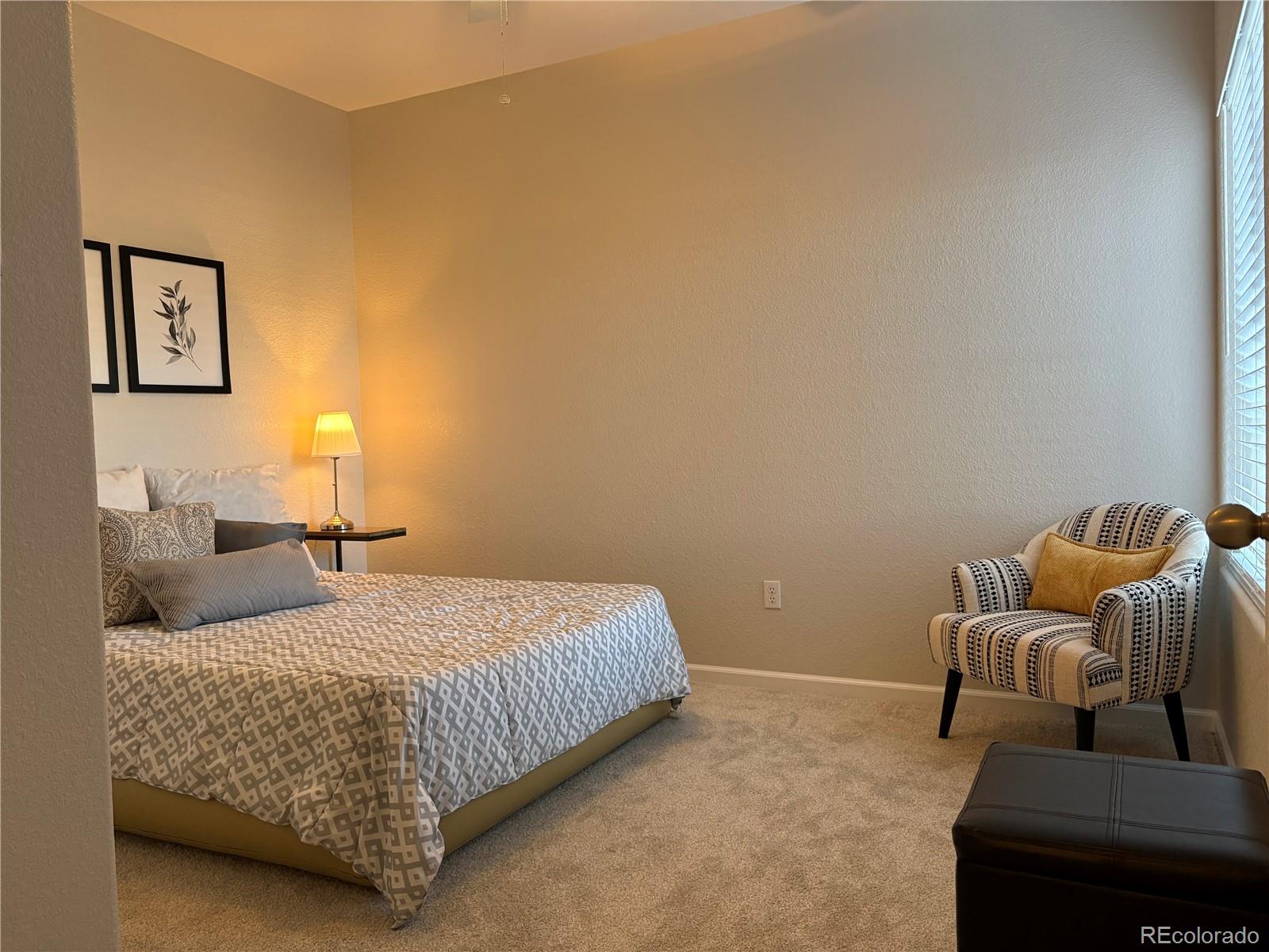 4608 Copeland Lane, Unit 101 Highlands Ranch, CO 80126 - Photo 12 of 16 a bedroom with a bed and couch