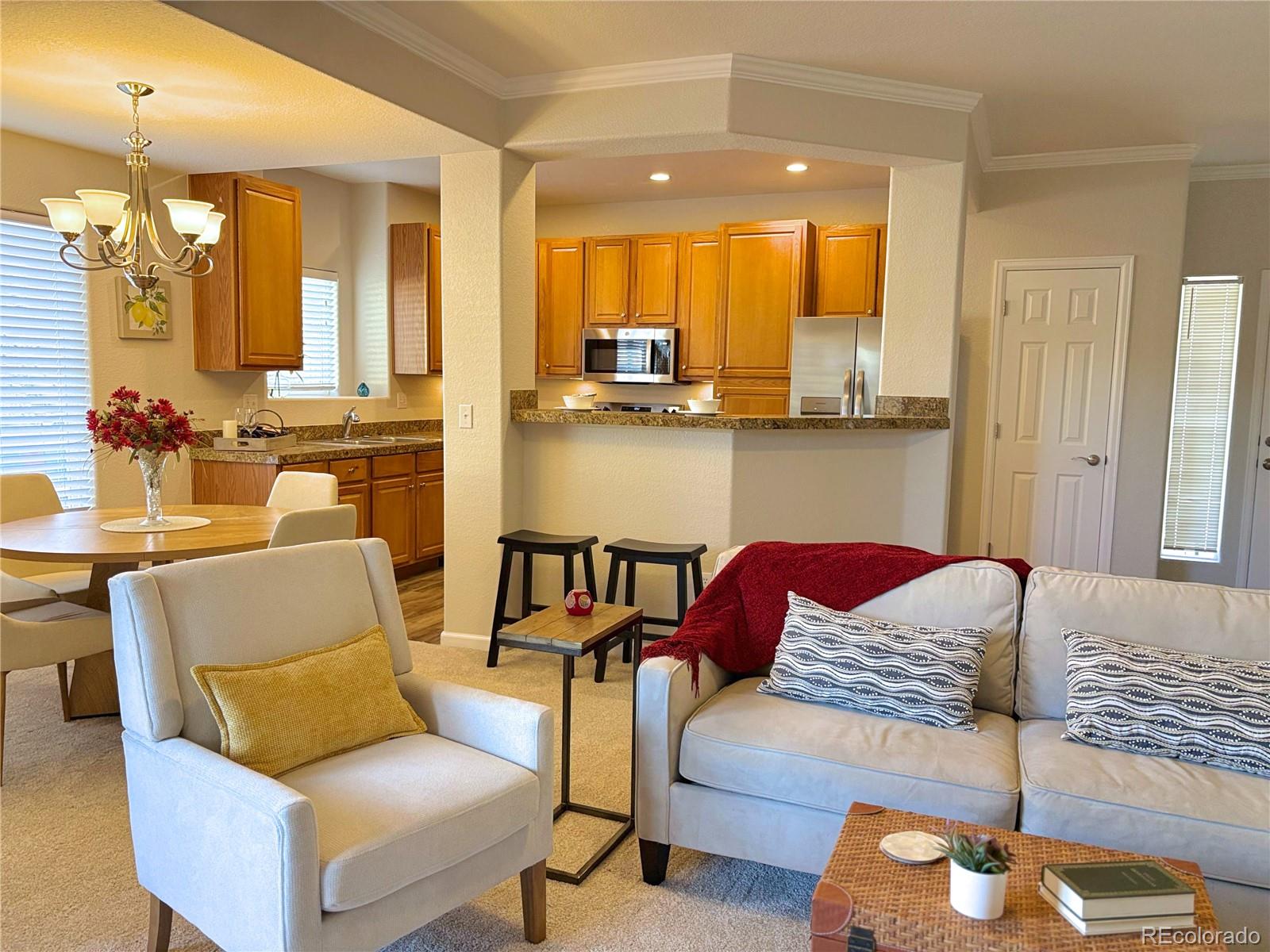 4608 Copeland Lane, Unit 101 Highlands Ranch, CO 80126 - Photo 2 of 16 a living room with furniture and a large window