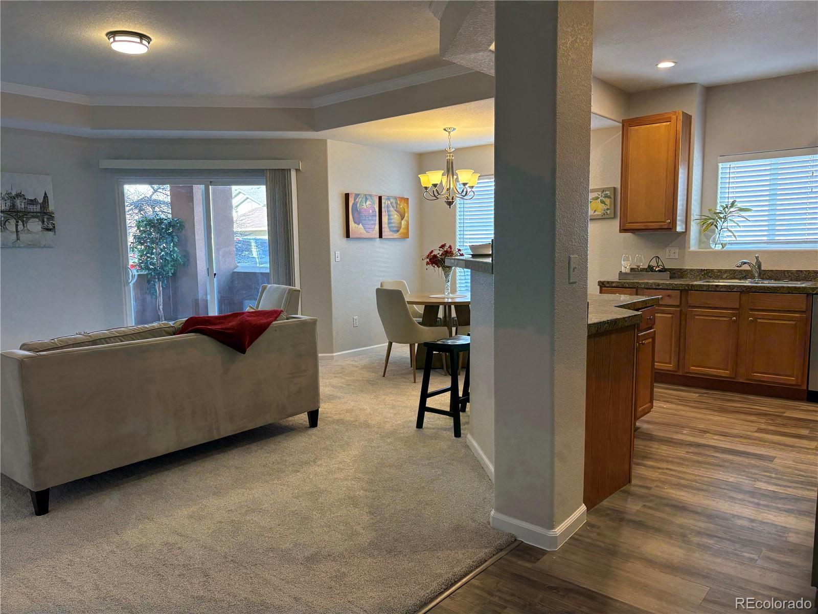 4608 Copeland Lane, Unit 101 Highlands Ranch, CO 80126 - Photo 4 of 16 a living room with furniture and kitchen