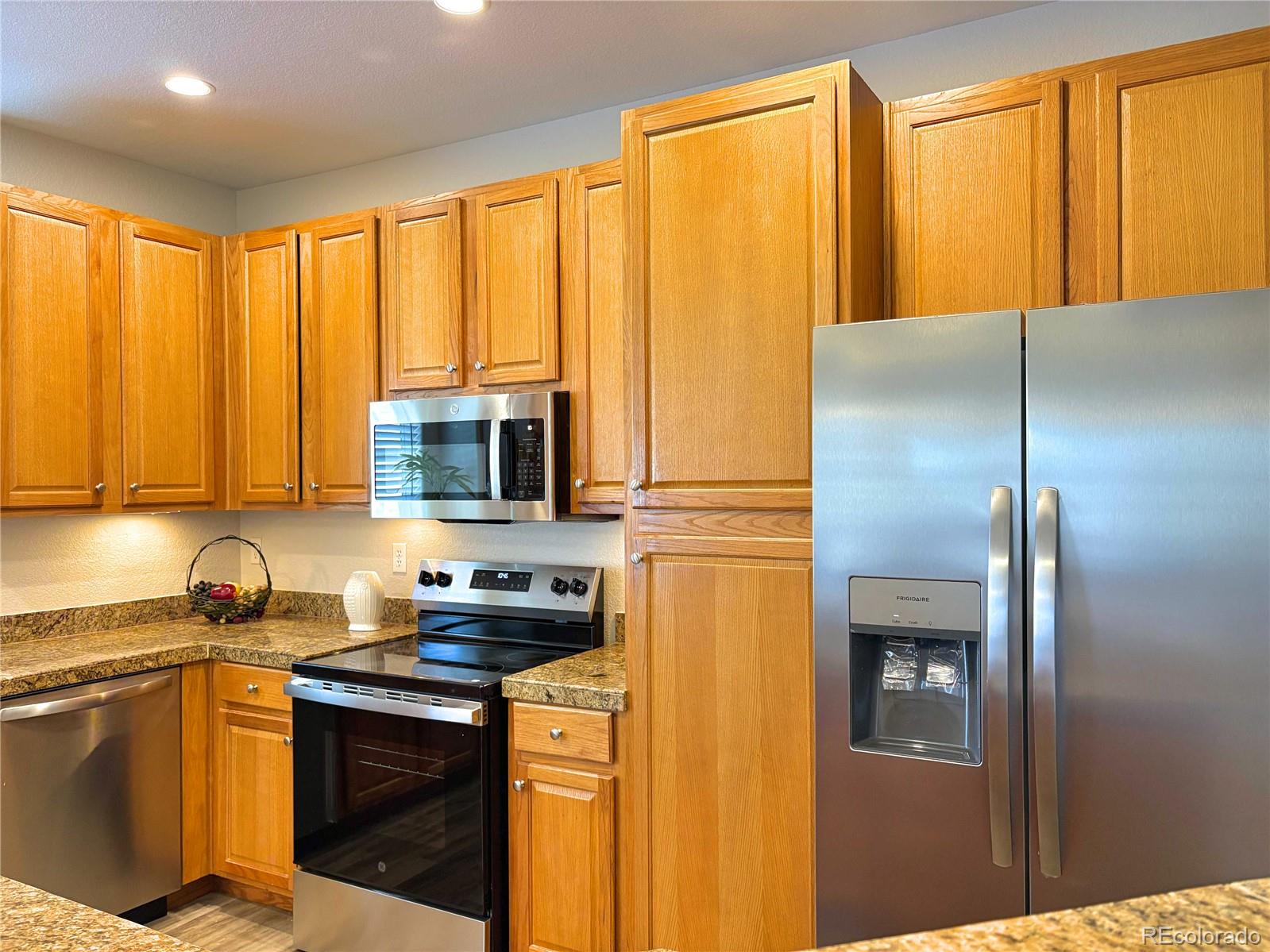4608 Copeland Lane, Unit 101 Highlands Ranch, CO 80126 - Photo 8 of 16 a kitchen with appliances cabinets and a sink