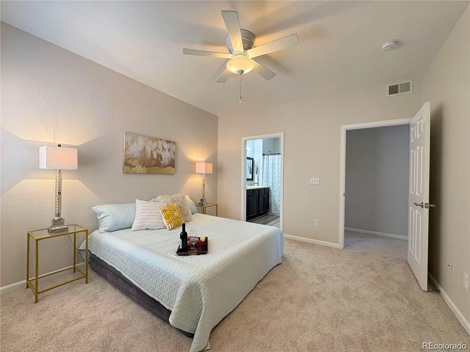 4608 Copeland Lane, Unit 101 Highlands Ranch, CO 80126 - Photo 10 of 16 a bedroom with a bed and a chandelier