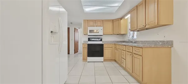 a kitchen with stainless steel appliances granite countertop a refrigerator and a stove