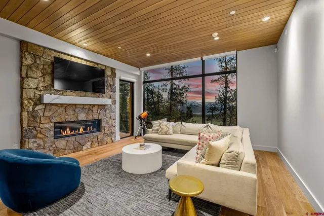 a view of a workspace with furniture and wooden floor