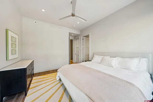 a bedroom with a large bed and a large window