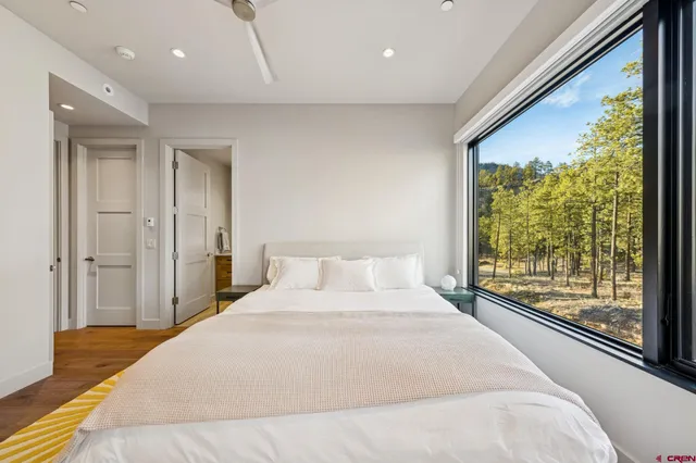 a bedroom with a bed and a large window