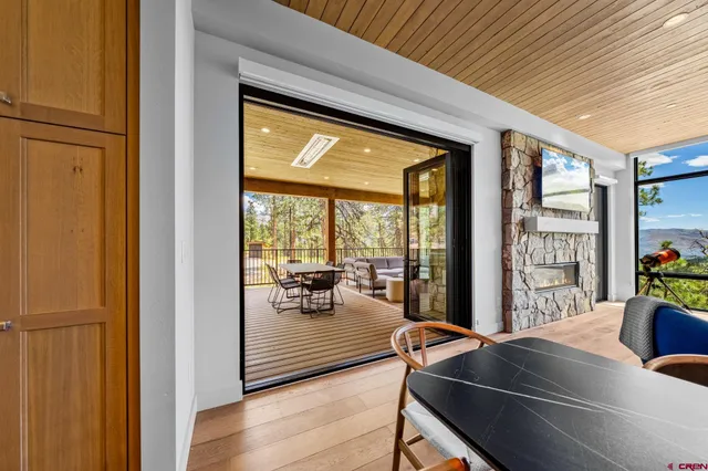 a large white kitchen with sink and wooden floor