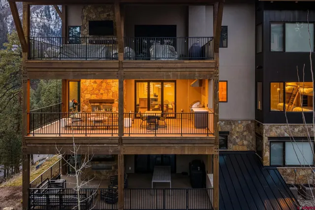 a view of a porch with wooden floor and iron stairs