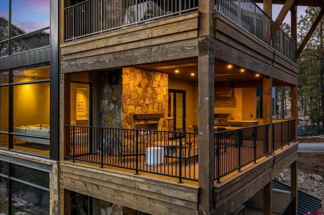 a balcony with wooden floor and outdoor seating