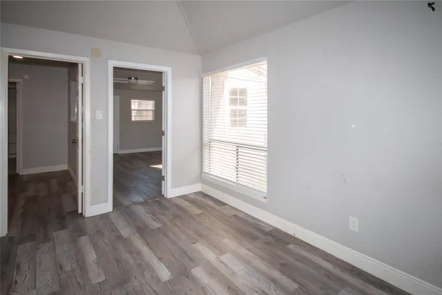 wooden floor in an empty room with a window