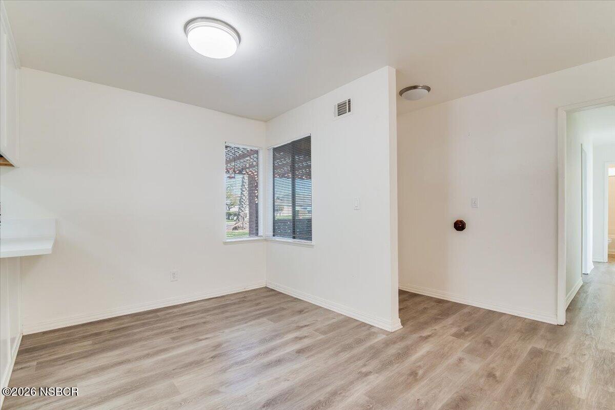 321 North Z Street Lompoc, CA 93436 - Photo 5 of 33 a view of an empty room with wooden floor and a window