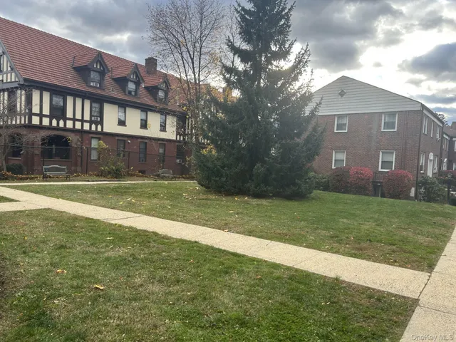 a view of a brick building next to a yard