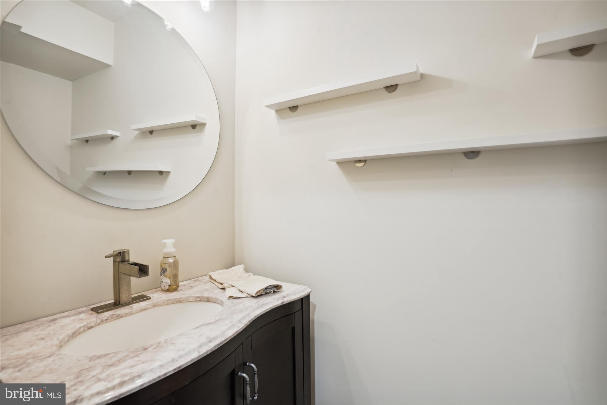 10408 Hunter Ridge Drive Oakton, VA 22124 - Photo 22 of 30 a bathroom with a granite countertop sink and a mirror