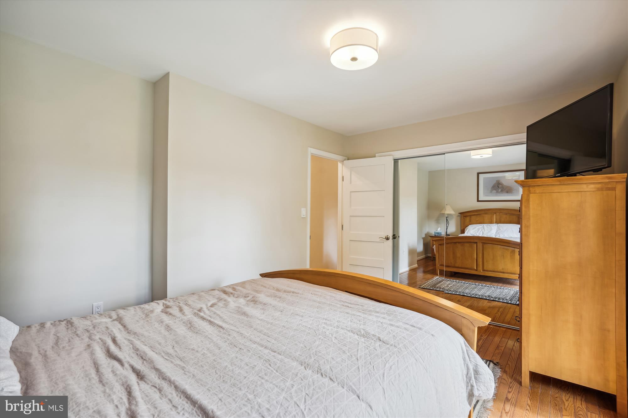 10408 Hunter Ridge Drive Oakton, VA 22124 - Photo 25 of 30 a bedroom with a bed and a flat screen tv