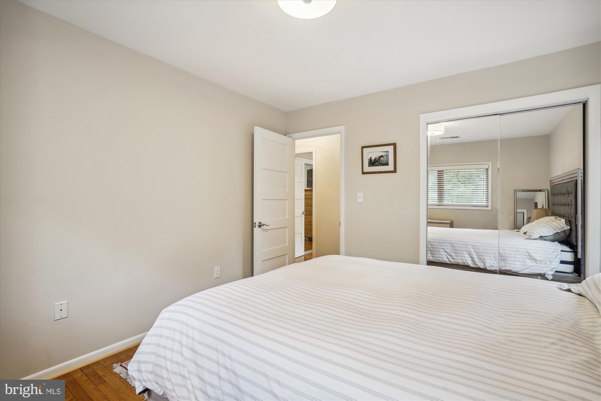 10408 Hunter Ridge Drive Oakton, VA 22124 - Photo 27 of 30 a bedroom with a bed and a mirror