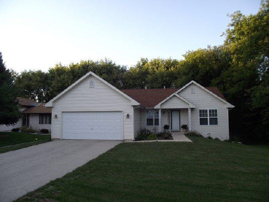 125 Pembroke Road Southwest Poplar Grove, IL 61065 - Photo 1 of 10 a front view of house with yard and green space