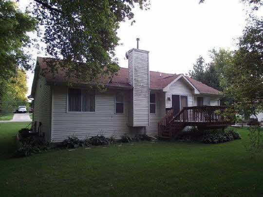 125 Pembroke Road Southwest Poplar Grove, IL 61065 - Photo 2 of 10 a front view of a house with a garden