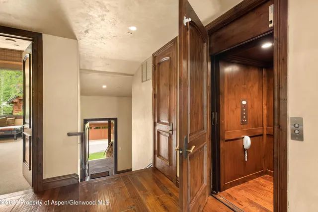 a view of staircase with white walls and a rug