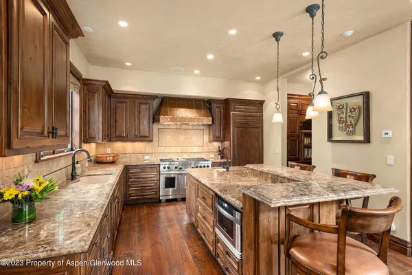 a living room with furniture tv and large windows