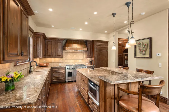 a living room with furniture tv and large windows