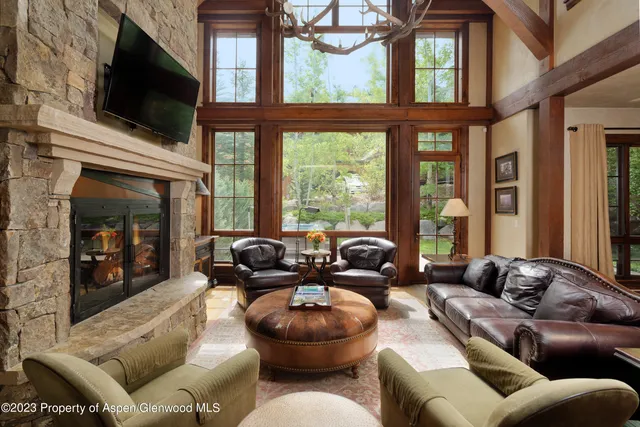 a living room with furniture a flat screen tv and a fireplace