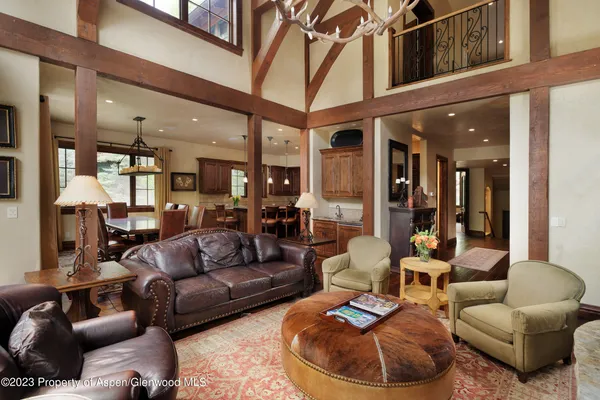 a view of a patio with table and chairs potted plants with wooden floor and fence