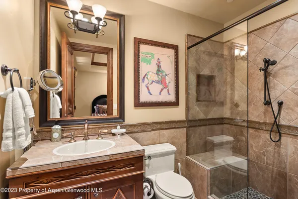 a bathroom with a sink mirror vanity and toilet