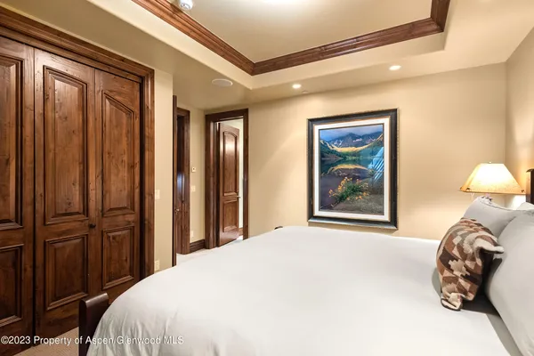 a bedroom with a bed and a painting on the wall