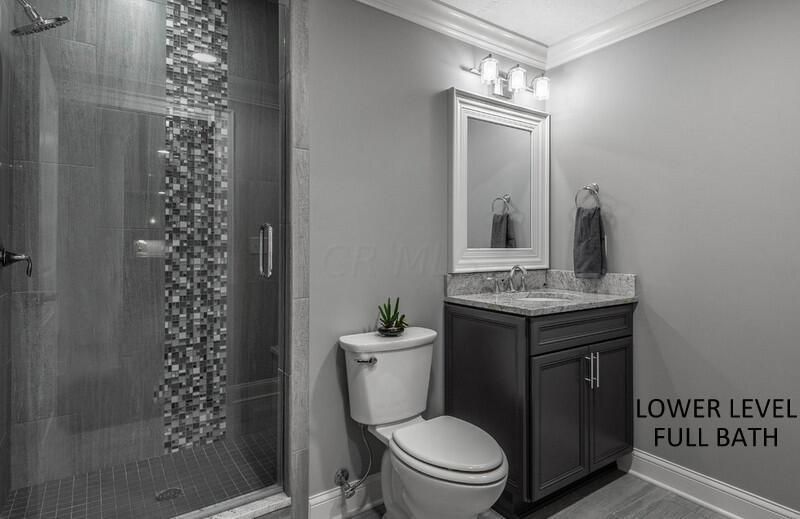 4459 Green Cook Road Johnstown, OH 43031 - Photo 78 of 103 LOWER LEVEL FULL BATH WITH CERAMIC TILE WALK-IN SHOWER, GRANITE TOP WOODMONT VANITY AND CROWN MOLDING