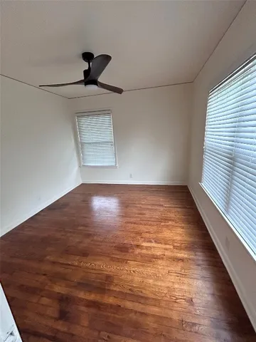 a view of room with window and wooden floor