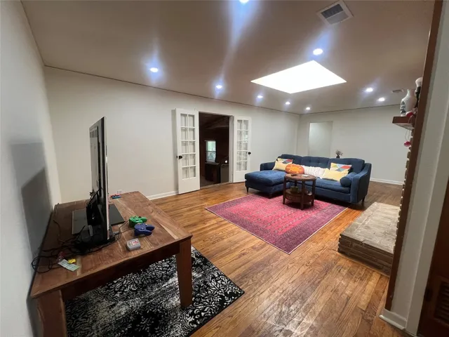 a bedroom with furniture and a wooden floor