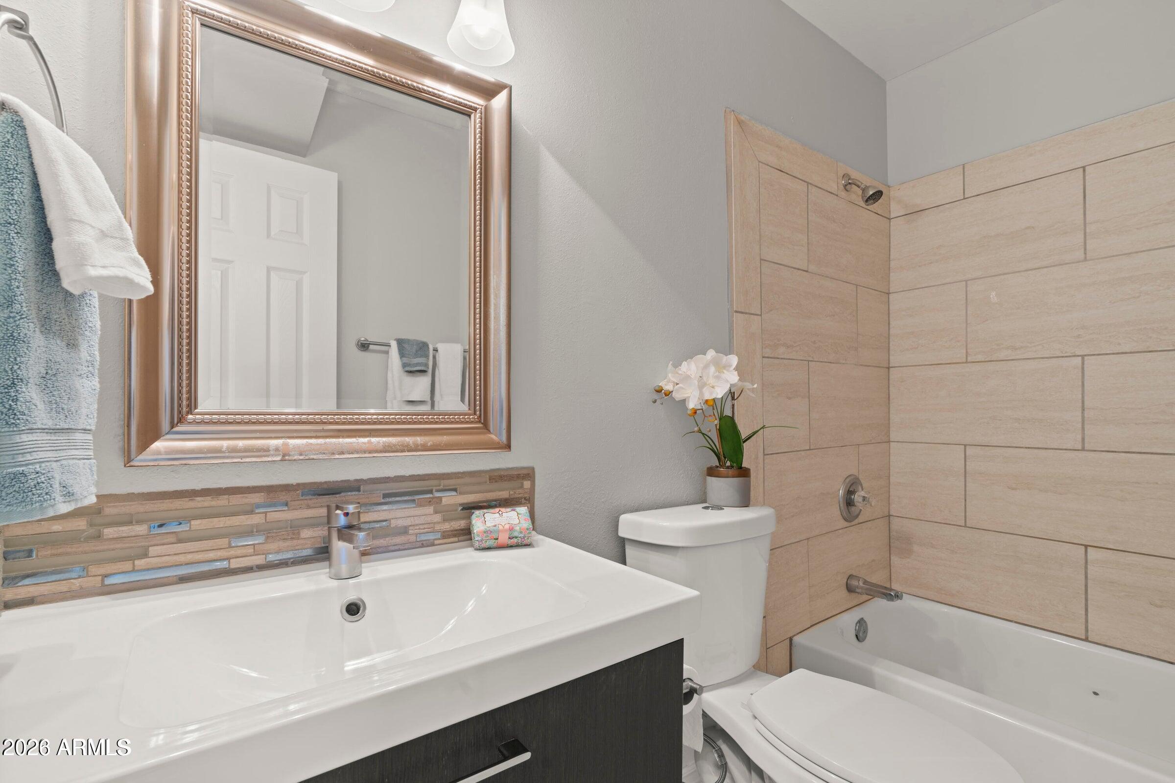 6909 East Osborn Road, Unit A Scottsdale, AZ 85251 - Photo 11 of 33 a bathroom with a sink a toilet and shower