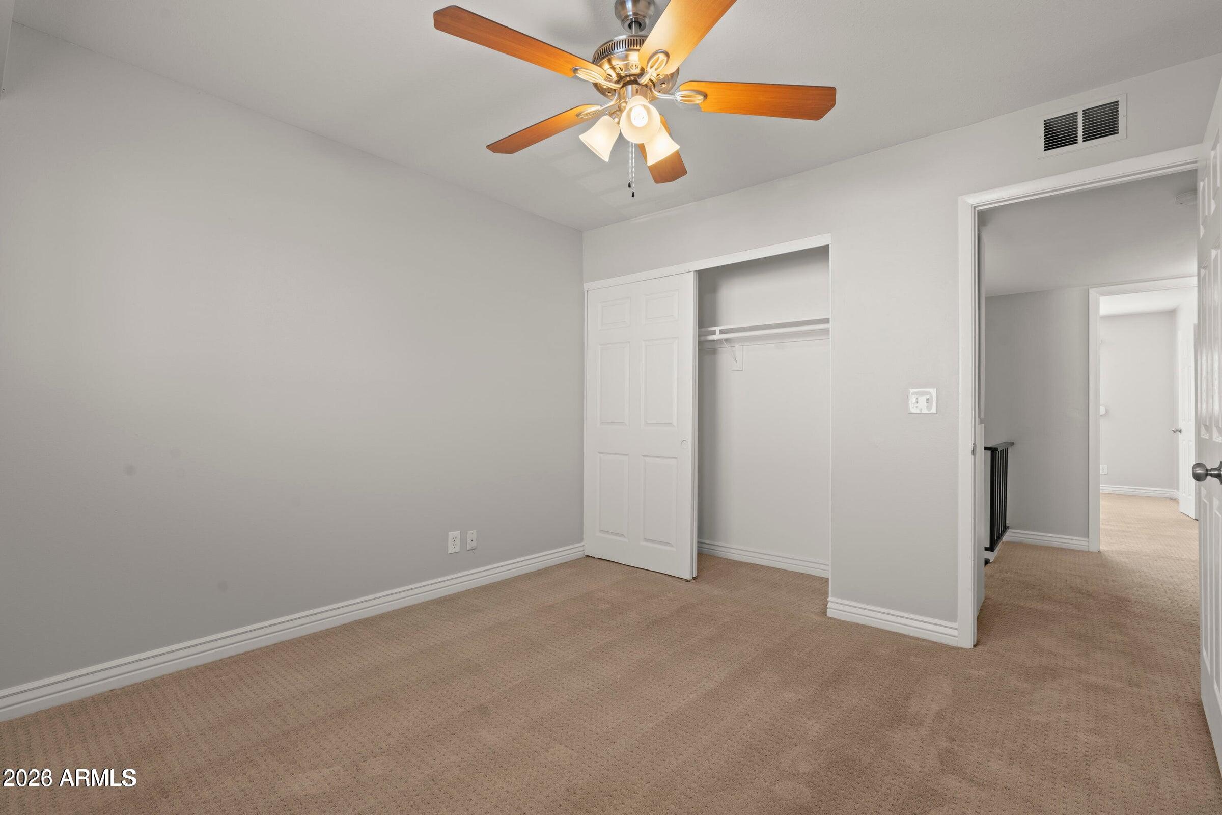6909 East Osborn Road, Unit A Scottsdale, AZ 85251 - Photo 12 of 33 an empty room with closet and fan