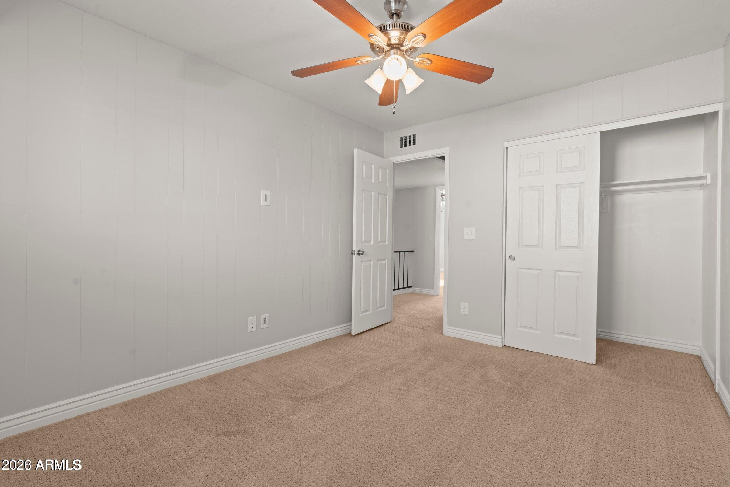 6909 East Osborn Road, Unit A Scottsdale, AZ 85251 - Photo 13 of 33 an empty room with closet and a chandelier fan