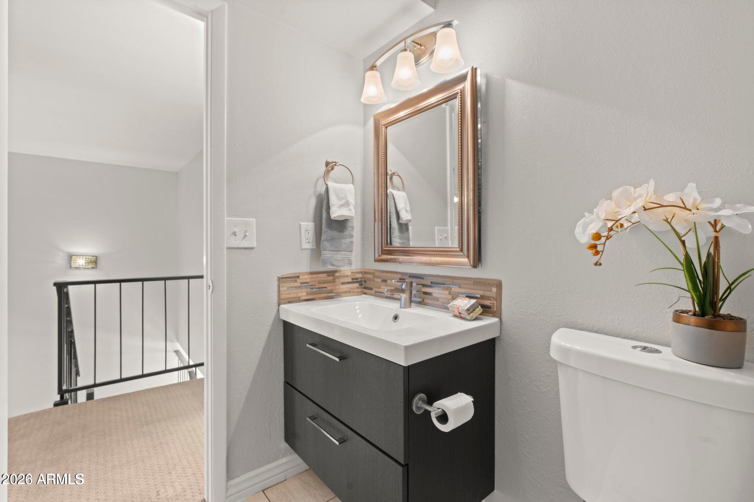 6909 East Osborn Road, Unit A Scottsdale, AZ 85251 - Photo 14 of 33 a bathroom with a sink vanity and a mirror