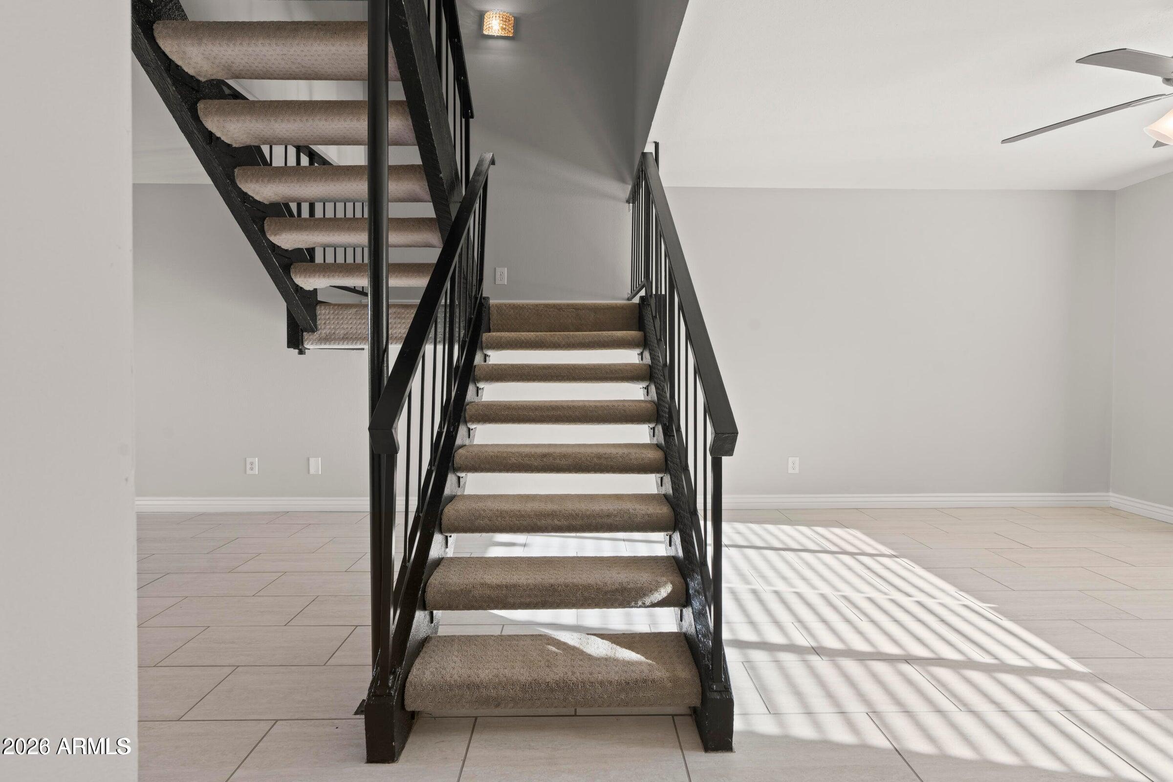 6909 East Osborn Road, Unit A Scottsdale, AZ 85251 - Photo 22 of 33 a view of staircase with white walls and a window