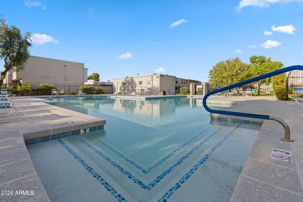 a view of a swimming pool with a patio