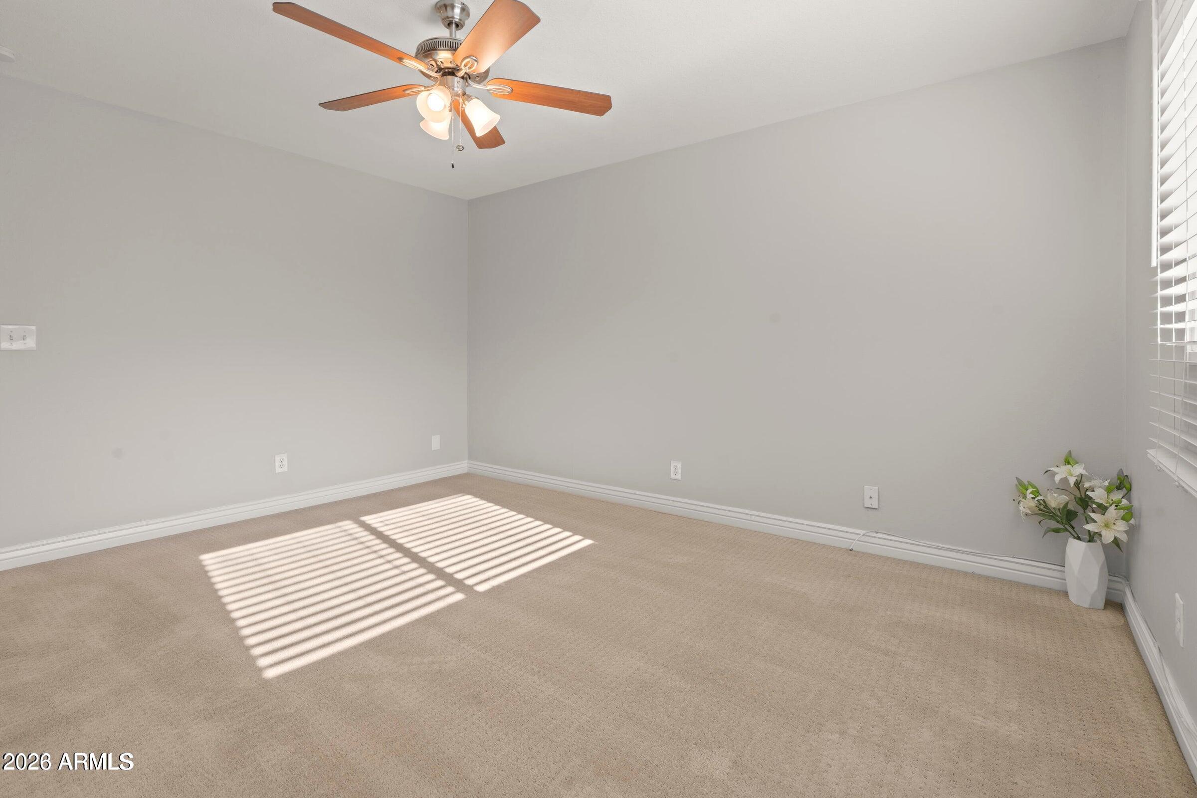 6909 East Osborn Road, Unit A Scottsdale, AZ 85251 - Photo 10 of 33 an empty room with windows and fan