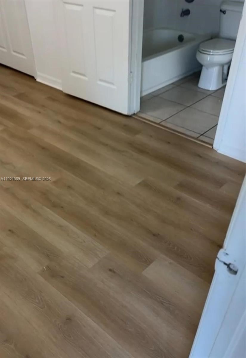 2475 Northwest 16th St Road, Unit 611 Miami, FL 33125 - Photo 7 of 11 a view of bathroom with bathtub and toilet