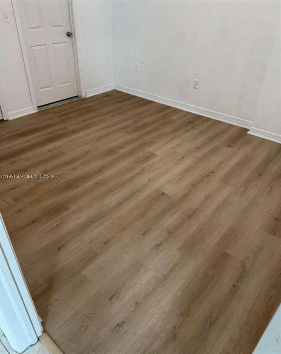 2475 Northwest 16th St Road, Unit 611 Miami, FL 33125 - Photo 8 of 11 a view of empty room with wooden floor