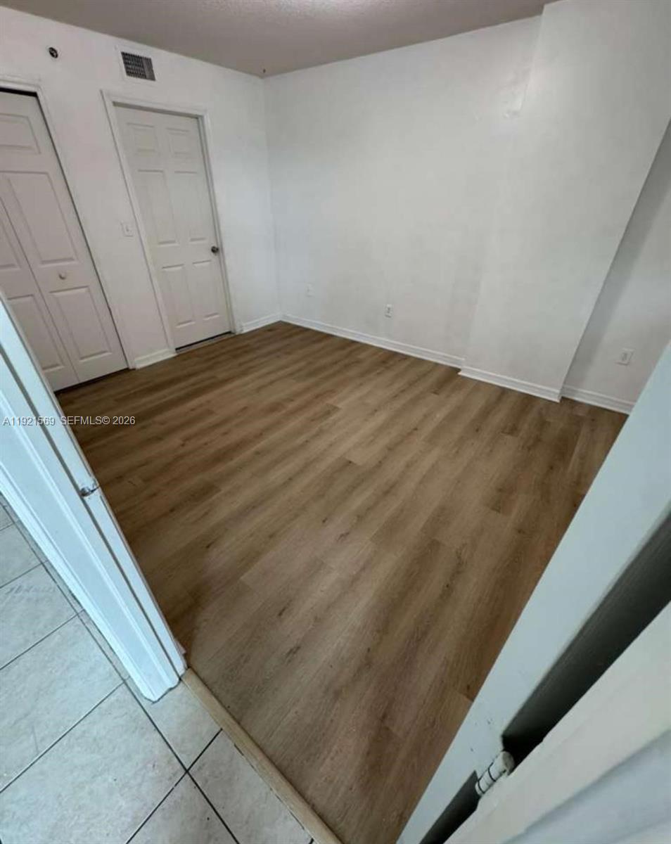 2475 Northwest 16th St Road, Unit 611 Miami, FL 33125 - Photo 9 of 11 a view of wooden floor