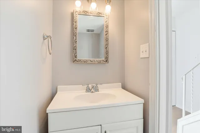 a bathroom with a sink and mirror