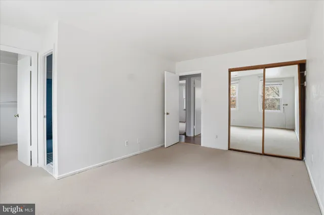 an empty room with sliding glass door and shower