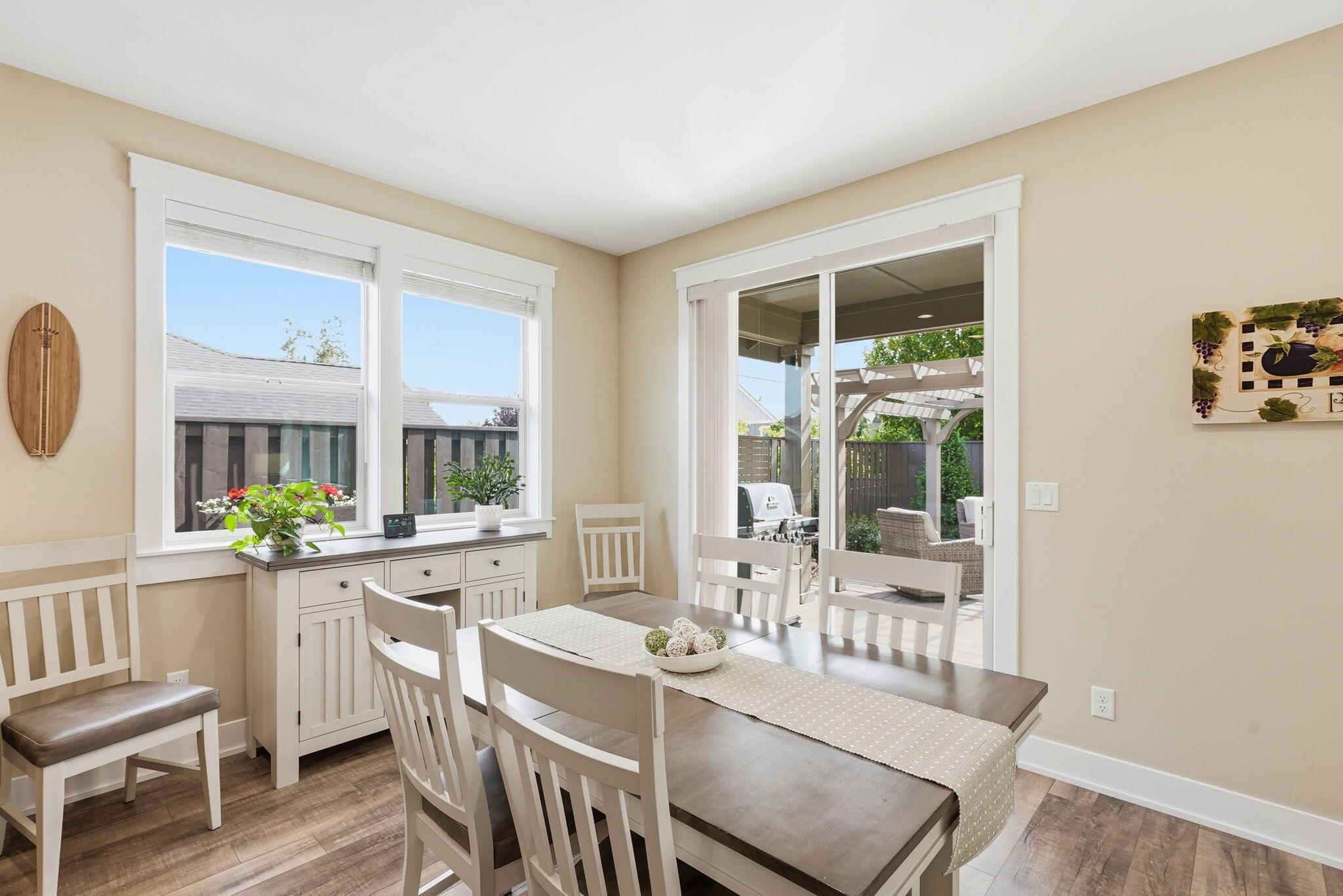 2714 Northwest 23rd Street Redmond, OR 97756 - Photo 17 of 57 a view of a dining room with furniture a potted plant and wooden floor
