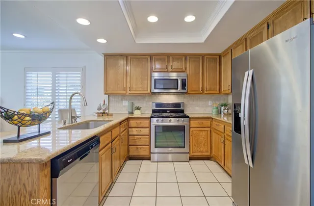a living room with furniture a fireplace and a large window