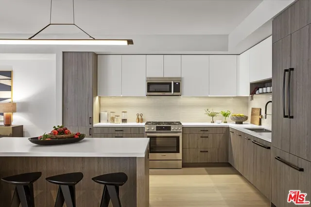 a kitchen with a sink a stove a refrigerator and cabinets