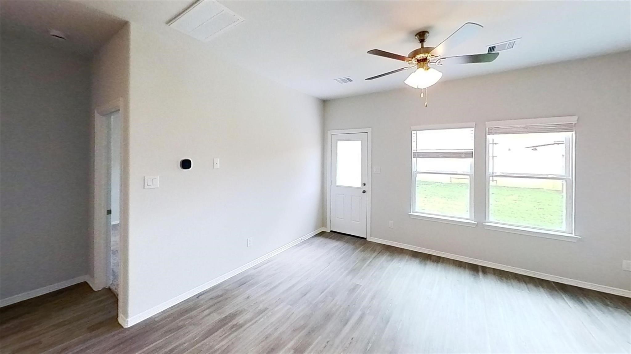 5826 Fresh View Court Katy, TX 77493 - Photo 2 of 7 a view of an empty room with wooden floor and a window