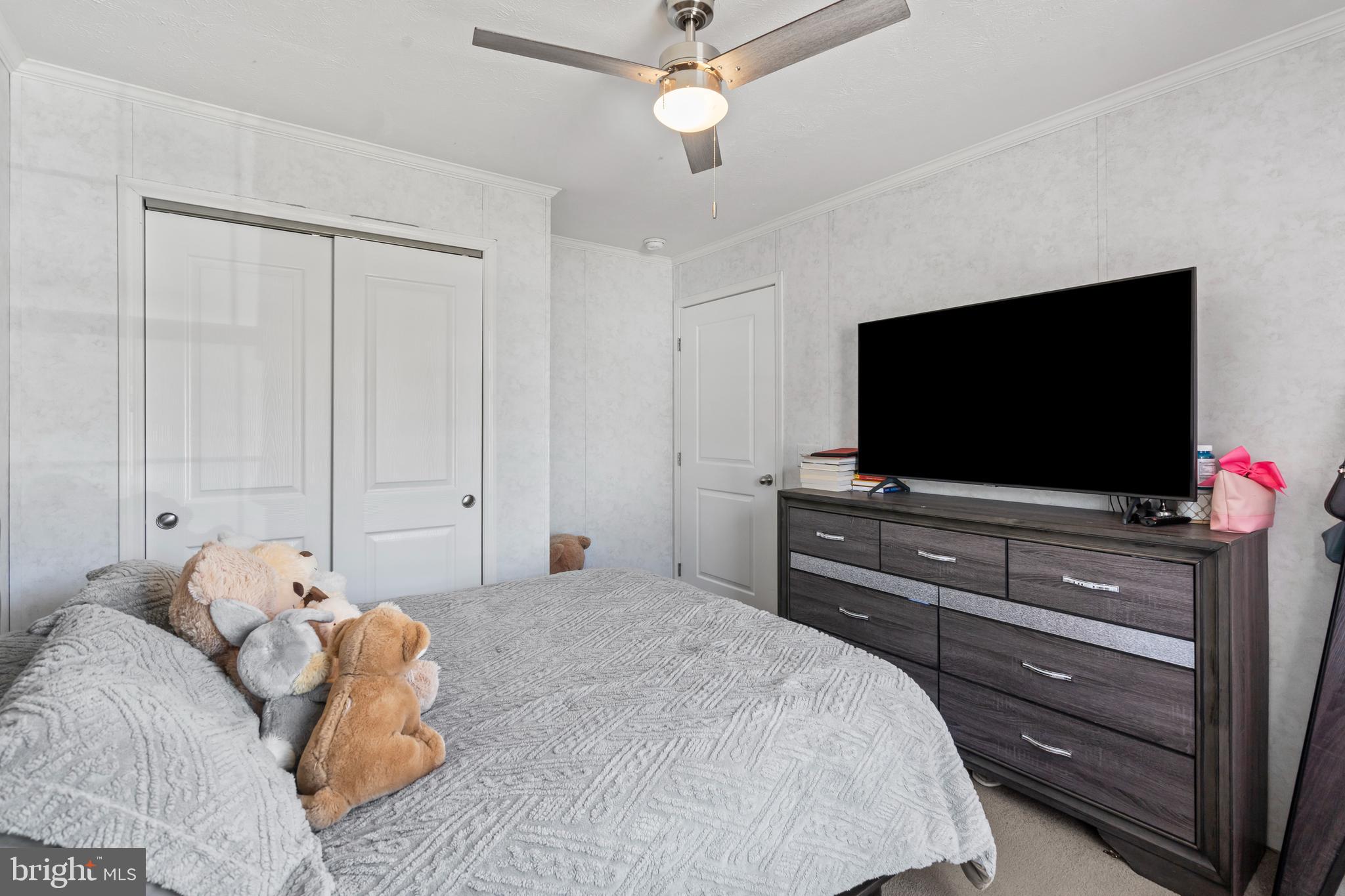 6 Southwind Circle Jackson, NJ 08527 - Photo 15 of 34 a bedroom with a bed and a flat tv screen on dresser