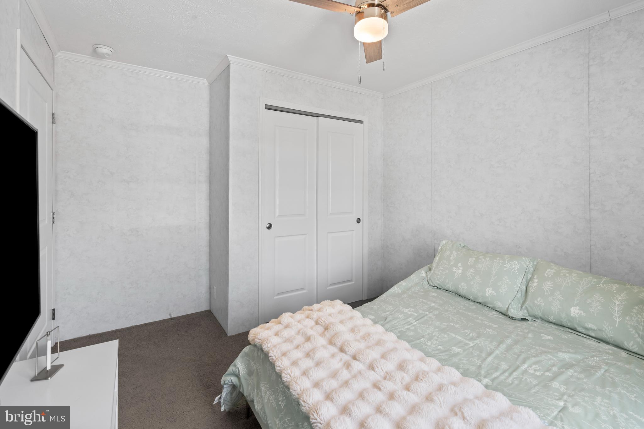 6 Southwind Circle Jackson, NJ 08527 - Photo 17 of 34 a bedroom with a bed and a chandelier