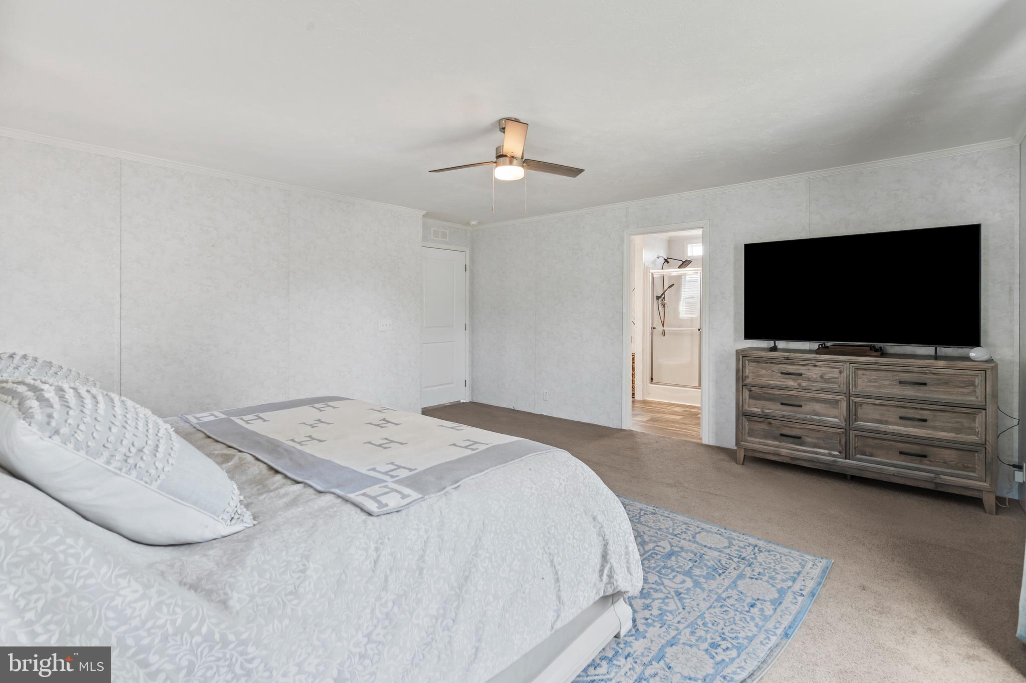 6 Southwind Circle Jackson, NJ 08527 - Photo 22 of 34 a bedroom with a bed and a flat screen tv